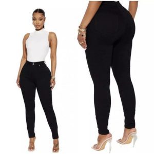Front view of woman wearing high-waisted black skinny jeans with a white bodysuit.