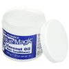 Open jar of Blue Magic Coconut Oil Hair Conditioner with lid beside it.