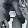 : Men’s black baggy denim jeans with raised handprint design front view