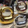 Front view of sculptural gold clutch purse