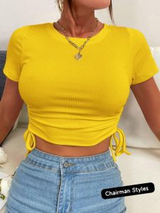 Woman wearing a short sleeve crop top styled with high-waisted jeans